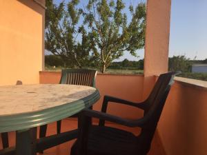a table and chairs on a balcony with a tree at Sunny Rock Volme Apartments in Banjole +17 photos