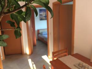 a dining room with a table and a room with a couch at Sunny Rock Volme Apartments in Banjole