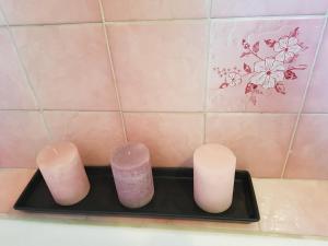 a group of four candles sitting on a black tray at NDP Family (Ndong Du Pierrier) in Montigny-lès-Cormeilles