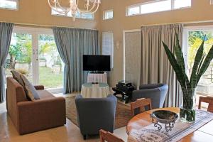 a living room with a couch and a table at Fairway Guest House in Durban