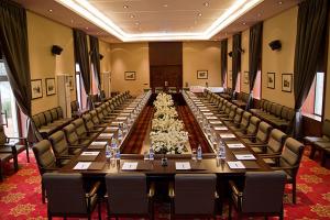 a large conference room with a long table and chairs at Golden Coast Hotel in Baku