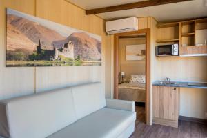 einen Wohnwagen mit einer Küche und ein Schlafzimmer mit einem Bett in der Unterkunft Magic Robin Hood in Albir
