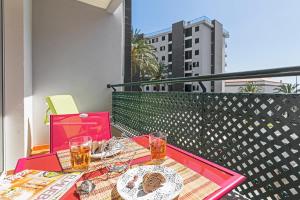 a table with a plate of food and drinks on a balcony at Ajuda II by An Island Apart in Funchal