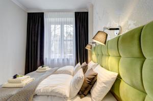 a bedroom with two beds and a large window at Balans Old Town in Gdańsk