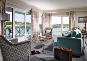 a living room filled with furniture and a large window at Trident Hotel Kinsale in Kinsale