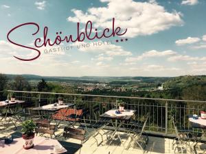 a view from a balcony with tables and chairs at Hotel Gasthof Schönblick in Neumarkt in der Oberpfalz
