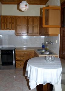 a small kitchen with a table and a sink at Adriana Studios in Perivólion