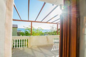 a view of the ocean from the balcony of a house at Apartmani Šimić in Starigrad