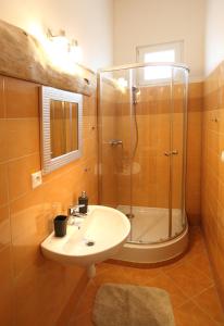 a bathroom with a sink and a shower at Penzión Ulička in Stupava