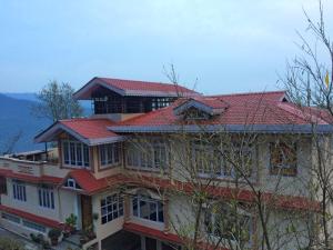 a large house with a red roof at The Di-Lac Retreat in Gangtok