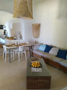 a living room with a couch and a table at Alicudi Giardino dei Carrubi- al gradino 365 in Alicudi +61 photos