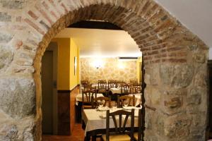 
a dining room table with a stone wall at San Miguel in Segovia
