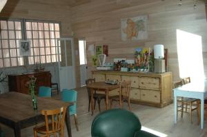a room with a table and chairs and a dining room at Le Clos de l'Abbaye in Cluny