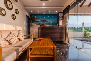 a living room with a couch and a table at Sia Resort in Nagaon