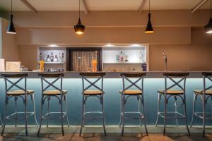 a bar with stools in front of a counter at Zakynthos Hotel in Tsilivi