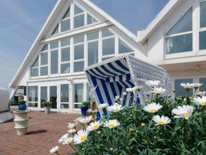 una silla azul y blanca frente a una casa en Haus Marinas, en Helgoland