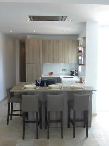 a kitchen with a table and chairs in a kitchen at Victoria Luxury Penthouse in Málaga