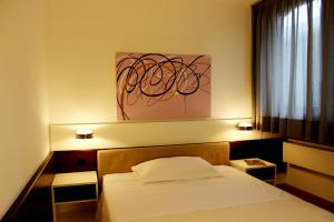 Postel nebo postele na pokoji v ubytování Hotel Garni Centro + 28 fotografií