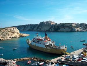 a boat is docked in a body of water at Hotel Kyrie Isole Tremiti in San Domino