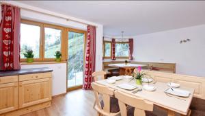 ein Esszimmer mit einem Tisch und einer Küche in der Unterkunft Michelas - Hof in Umhausen