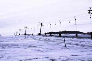 a snow covered field with a ski lift at Apartmány Cestář Boží Dar in Boží Dar