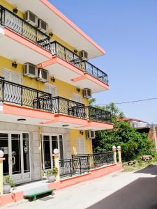 a building with balconies on the side of it at Studios Elena in Limenaria