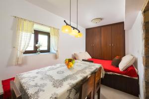 a bedroom with a table and a bed with a red mattress at Villa Claudia in Lardos in Lartos