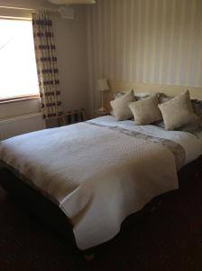 מיטה או מיטות בחדר ב-Windsor Lodge B&B