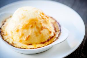 a cupcake with a scoop of ice cream on a plate at The Kings Arms in Christchurch