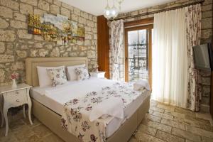 a bedroom with a large bed and a tv at İncekara in Alacati