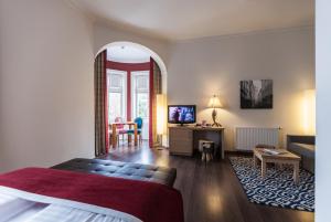 Hotel Villa Carlton - Adults Only في سالزبورغ: غرفة نوم مع سرير وغرفة معيشة