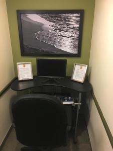 
a desk with a computer on it at Super 8 by Wyndham Amherst NS in Amherst
