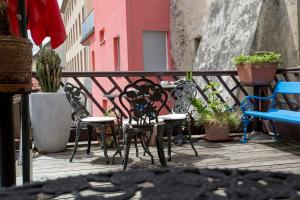 a table and chairs on a balcony with plants at Baderhaus in Bruck an der Mur
