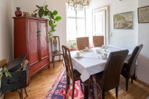 a dining room with a white table and chairs at Baderhaus in Bruck an der Mur