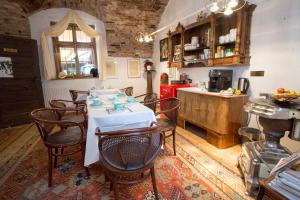 a kitchen with a table and chairs in a room at Baderhaus in Bruck an der Mur