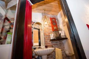 a bathroom with a sink and a brick wall at Baderhaus in Bruck an der Mur