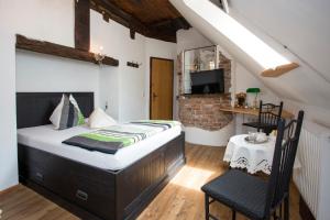 a bedroom with a bed and a table and a chair at Baderhaus in Bruck an der Mur