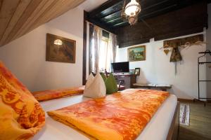 a bedroom with two beds and a desk with a laptop at Baderhaus in Bruck an der Mur
