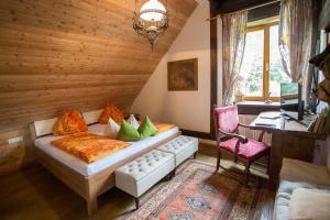 a bedroom with a bed and a chair in a room at Baderhaus in Bruck an der Mur