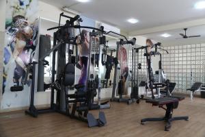 a gym with a woman working out in it at Hotel Santo Graal in Aparecida +50 photos
