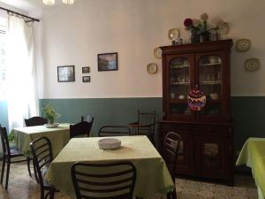 a dining room with two tables and a cabinet at Alloggio Agrituristico DODICI-APOSTOLI in Casumaro