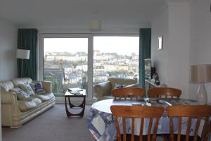 a living room with a couch and a table at Sea Crest in Brixham