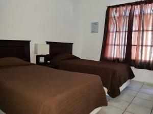 Hotel Marina Topolobampo tesisinde bir odada yatak veya yataklar