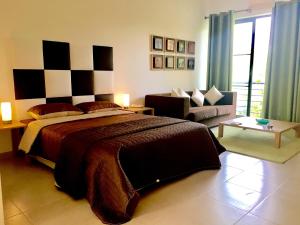 a bedroom with a large bed and a couch at SR Palmela Village Studios II in Quinta do Anjo +52 photos