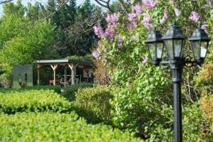 a street light in a garden with a gazebo at Les Carmes and spa in Le Thor
