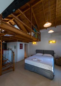 A bed or beds in a room at Kalamata Suites