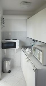 バラトンレッレにあるLidó Társasnyaralóの白いキッチン(電子レンジ、コンロ付)