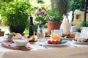 a table with plates of food and a bottle of wine at Masseria Valente in Ostuni
