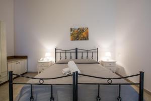 a bed in a bedroom with two night stands and two lamps at Masseria Valente in Ostuni