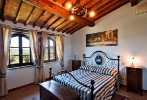 a bedroom with a bed in a room with windows at La Dragona in Castel del Piano